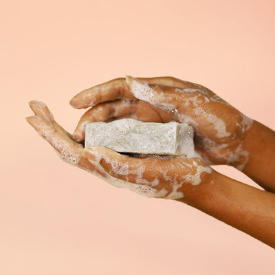 lathered hands holding a bar of all natural grapefruit & himalayan pink salt bar soap | herbneden